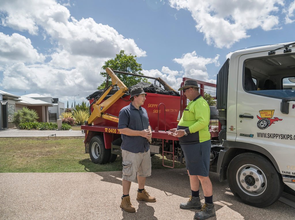 Skippy Skips truck and driver with customer