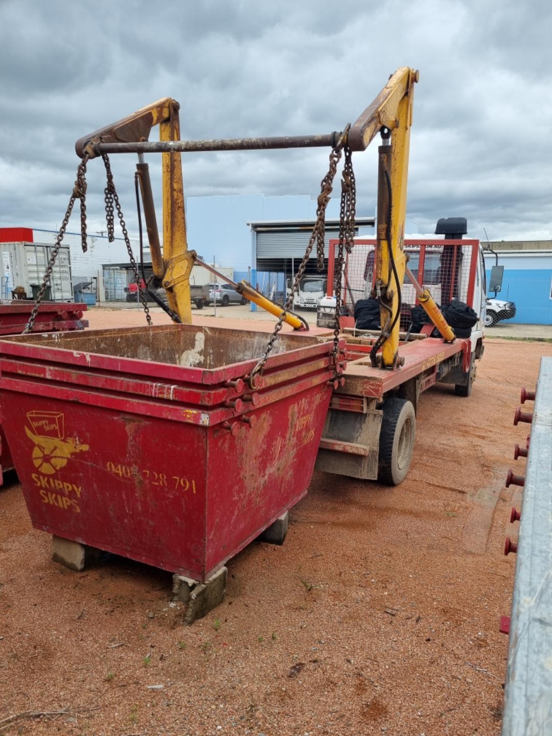 Skippy Skips red skip bin on a work site